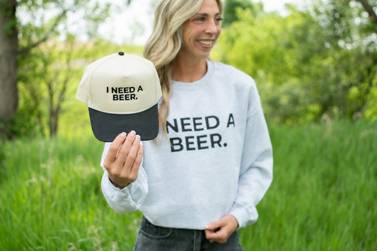 'I Need A Beer.' Embroidered Trucker Hat: Cream/Black